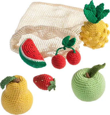 A collection of crocheted fruits and a mesh bag on a white background.