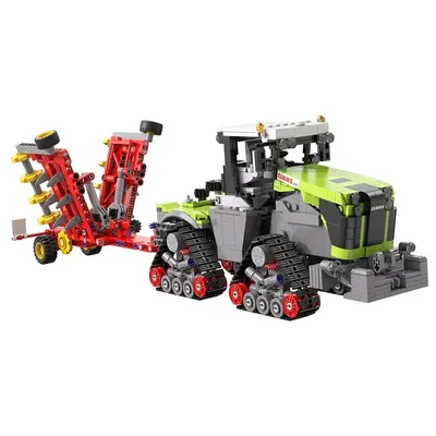A toy tractor with a plow attachment, displayed against a white background.