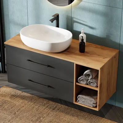 A modern bathroom vanity with a sink and faucet.