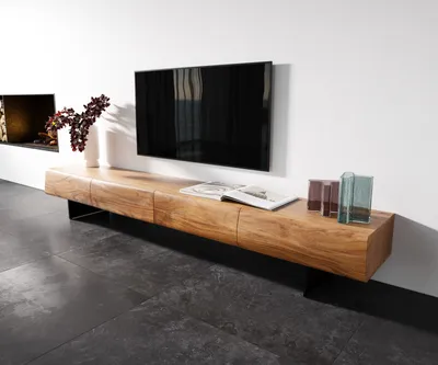 A modern living room with a wall-mounted TV and a wooden media console.
