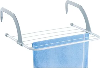 A close-up view of a towel drying rack with a blue towel on it, against a white background.