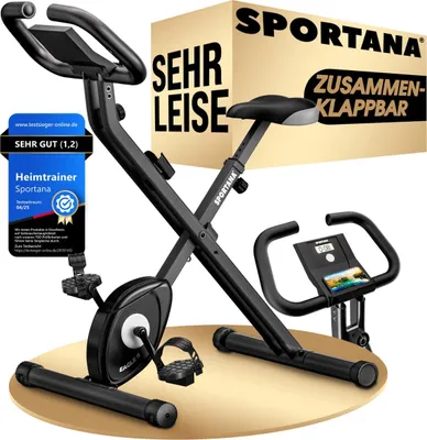 A black exercise bike is displayed on a light beige circular platform against a white background. A cardboard box with the brand name and product features is behind the bike.