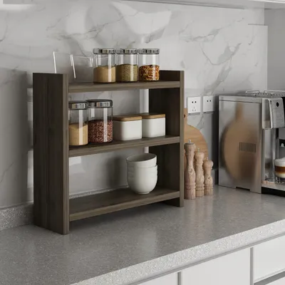 A kitchen counter with a spice rack, coffee maker, and other kitchen items.