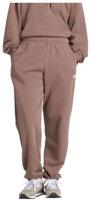 Zdjęcie produktu dla Spodnie New Balance Pantalón largo New Balance Sport Essentials French Terry Jogger marrón mujer dla Uni