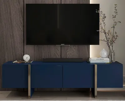 A modern living room setup featuring a TV stand with a television mounted above it.