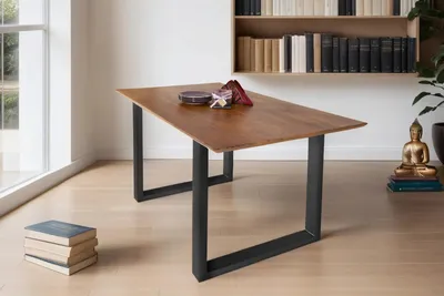 A dining table in a room with a bookshelf and a window.