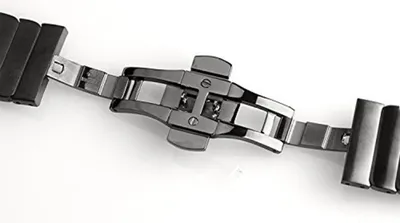 A close-up view of a watch clasp and part of a watch band.