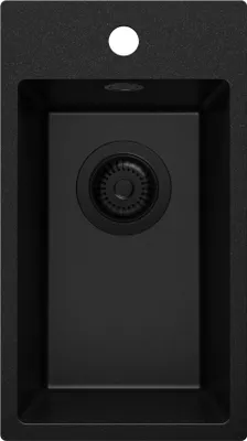 A top-down view of a black granite kitchen sink with a drain.