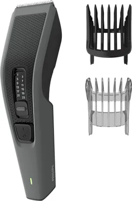 A hair clipper and its accessories are displayed against a white background.