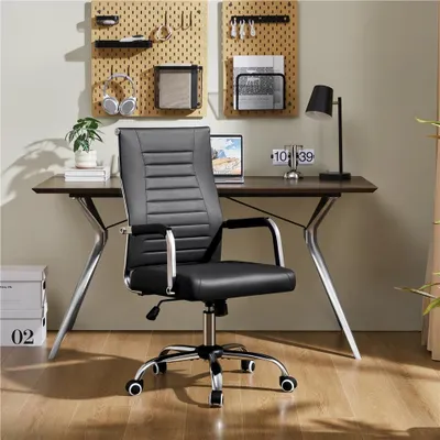 A black office chair is placed in front of a desk in a home office setting.