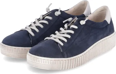 A pair of blue leather sneakers with white laces and thick white soles, shown from a slightly elevated side angle against a white background.