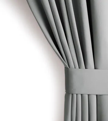 A close-up of a gray curtain with pleats and a tie-back.
