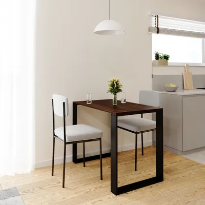 A small dining table with two chairs in a kitchen setting.