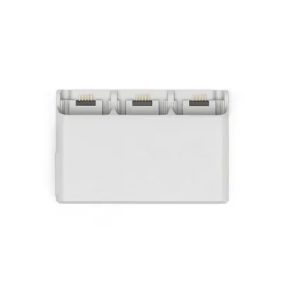 A white battery charging station for a DJI drone.