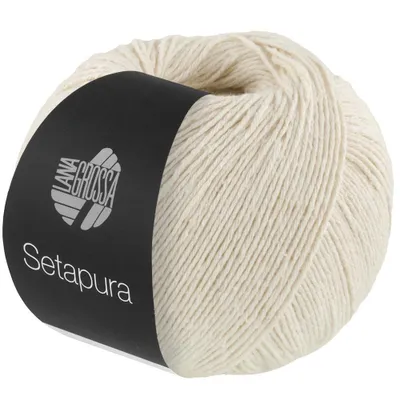 A ball of cream-colored yarn with a black label.