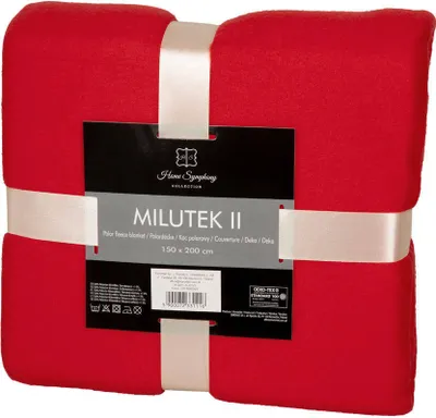 A red fleece blanket is folded and tied with a white ribbon, with a product label attached.