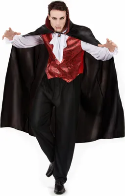 A man dressed in a vampire costume, posing with arms outstretched.