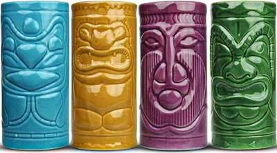 Four tiki mugs in different colors lined up against a white background.