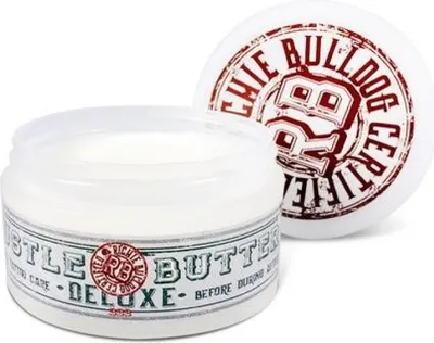 A jar of Hustle Butter Deluxe tattoo cream and its lid are shown against a white background.