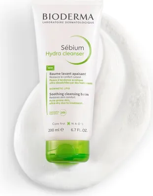 A tube of Bioderma Sebium Hydra Cleanser is shown on a white foamy background.