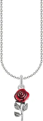 A close-up studio shot of a necklace with a rose pendant.