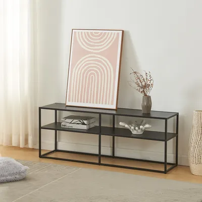 A black metal media console with two shelves, decorated with a framed abstract art piece, a vase with dried flowers, and a decorative bowl.