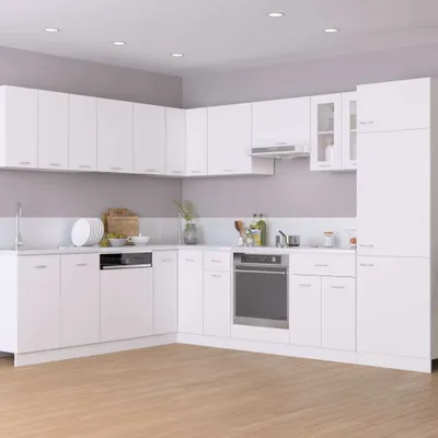 A clean, modern white kitchen with white cabinets and appliances.