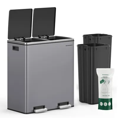 A grey dual-compartment trash can with two black inner bins and a bag of trash bags.