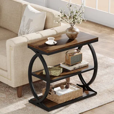 A narrow side table with a wooden top and black metal frame, placed next to a sofa in a living room setting.