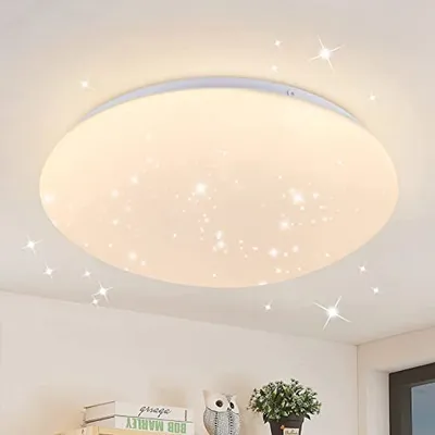 A ceiling light with a star pattern is shown on a white ceiling.