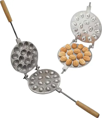 A baking mold for making nut-shaped cookies, shown open with some cookies inside.