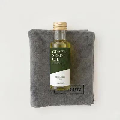 TheWootz starterspakket 20 ml: flesje druivenpitolie op een grijze microvezeldoek