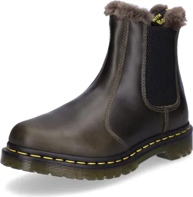 A single brown Dr. Martens boot with faux fur lining is shown against a white background.