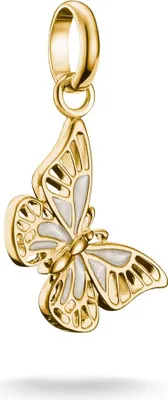 A gold-colored butterfly charm with white enamel details, suspended from a gold bail.