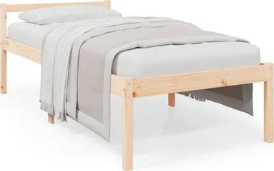 A wooden bed frame with a mattress, pillow, and blanket.