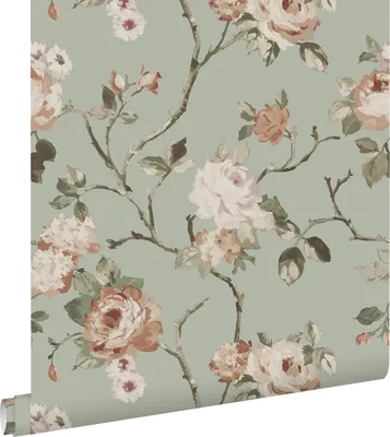 A roll of floral wallpaper with a mint green background and pink and white roses.