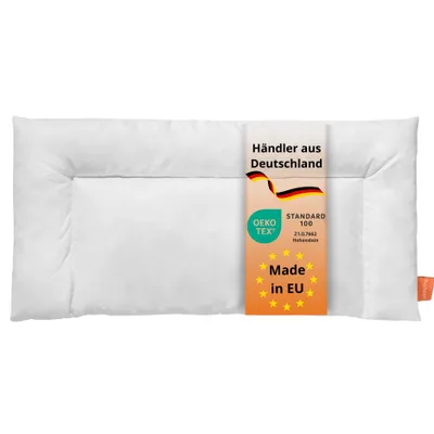 A white pillow with a tag attached.