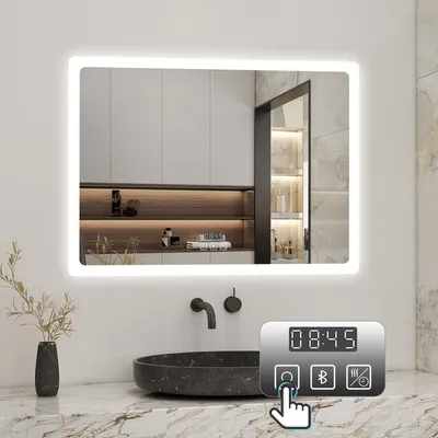 A modern bathroom with a large LED mirror above a sink. A control panel with a clock and icons is visible in the foreground.