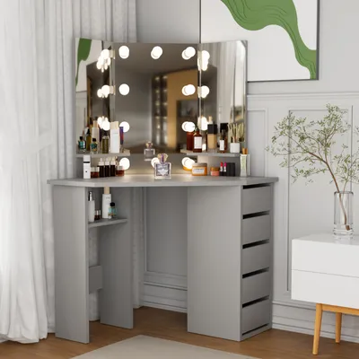 A vanity table with a lighted mirror and makeup products is set up in a room with curtains and a piece of art on the wall.