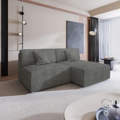 A modern living room with a grey sectional sofa, abstract wall art, and a floor lamp.
