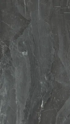 A close-up, full-frame image of a dark gray marble-look vinyl tile with white veining.