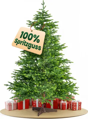 A green artificial Christmas tree with presents underneath and a tag indicating "100% Spritzguss".