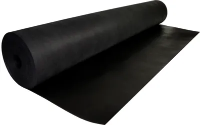 A roll of black landscape fabric is partially unrolled on a white surface.