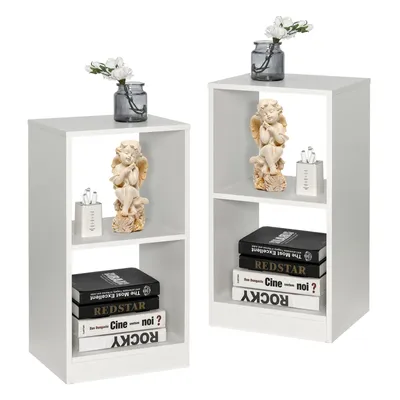 Two white wooden bookshelves with decorative items and books.