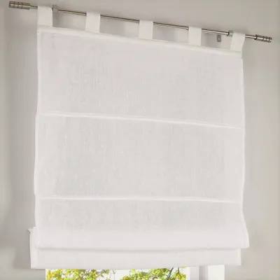 A white linen Roman blind hanging on a window.