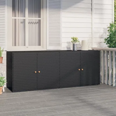 A black poly rattan garden cabinet with four doors is shown on a wooden deck in front of a white house with shutters.