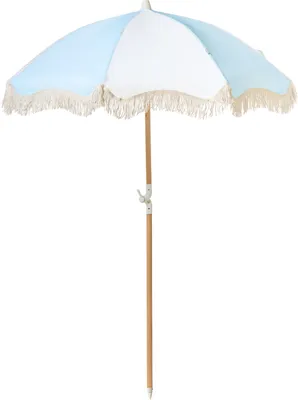 A light blue and white beach umbrella with fringe detail and a wooden pole, isolated on a white background.