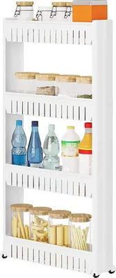 A white, narrow shelving unit with four tiers, filled with various kitchen items like jars of spices, bottles of liquids, and pasta.