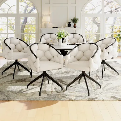 A dining room set with chairs around a table, in a well-lit room with large windows.