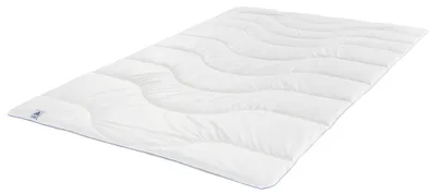 A white duvet is laid out flat on a white background.